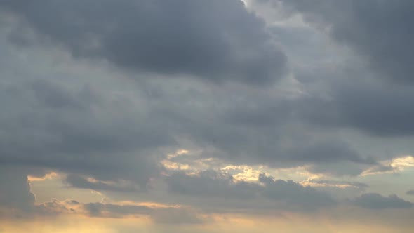 Time Lapse of Cloudy Sunset with City in the Background alt