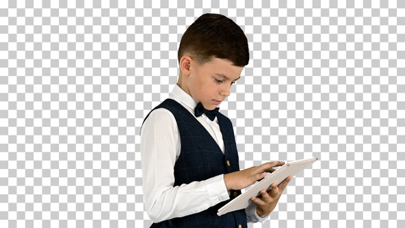 Concentrated boy using digital tablet while standing, Alpha Channel alt