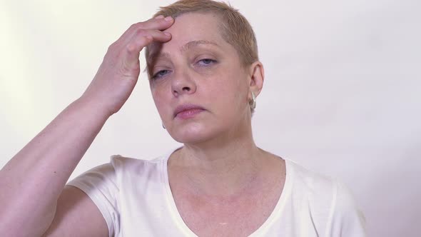 Mature Woman Checking and Looking at Her Face Condition alt