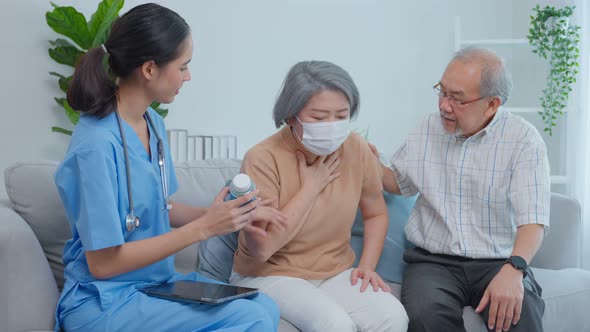 Asian senior older couple consult with caregiver woman at nursing home. alt