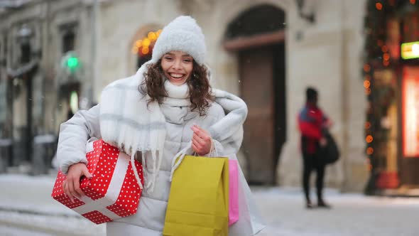 A Woman is Going to the City Center During a Snowfall alt