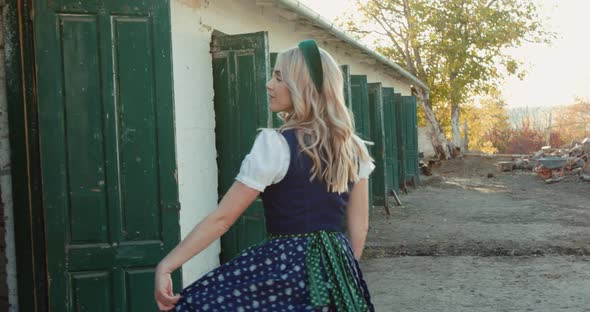 Beautiful Blonde in Ethnic Dress Poses and Whirls at Near Stable in Rural Place alt
