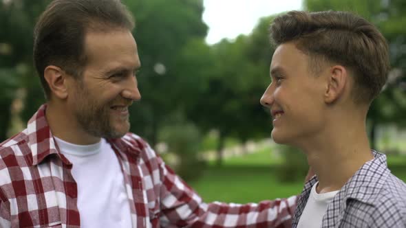 Proud Father Hugging His Intelligent Son, Care and Love, Happy Fatherhood alt