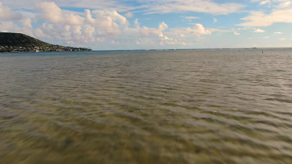drone low fly out to ocean crystal clear water and sand alt