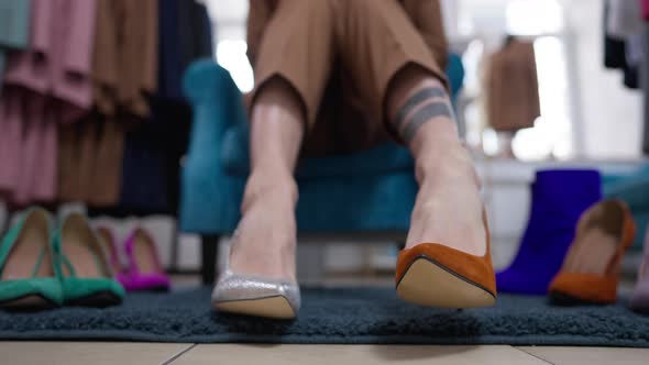 Closeup Male Legs in Different Highheels in Shoe Shop Indoors alt