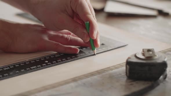 Carpenter Makes Pencil Markings on the Blank with the Help of a Ruler