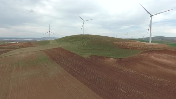 Wind Power Plant on Edge of Brown Treeless Fields in Vast Plain alt