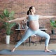 Pretty Pregnant Woman Does Breathing Exercises at Home