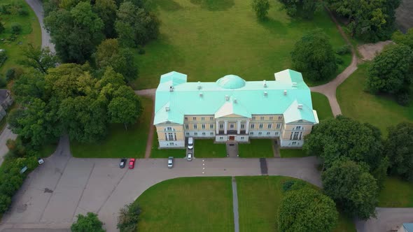 Mezotne Palace and Park With Fountain in Latvia. Lielupe River With Ponton Bridge Aerial 4K alt