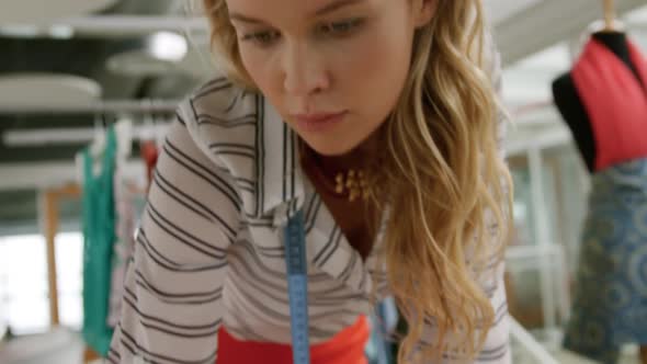 Young woman working in a fashion studio alt