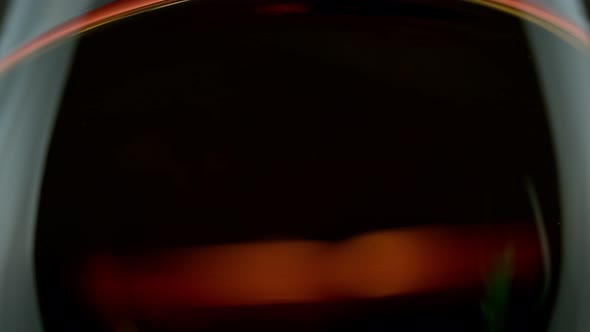 Super Slow Motion Macro Shot of Swirling Whiskey in Glass at 1000Fps alt