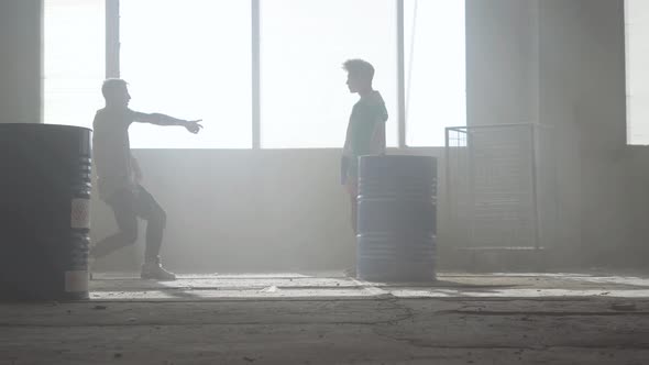 Dance Battle of Two Street Dancers in an Abandoned Building Near the Barrel alt