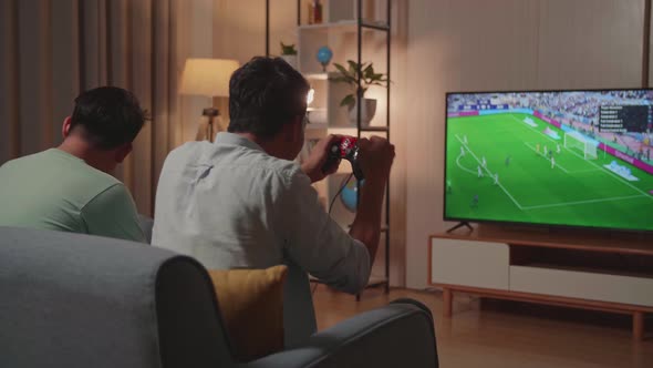 Cheerful Young Friends With Joystick Game Play Soccer Video Game On Tv And Celebrating Victory alt