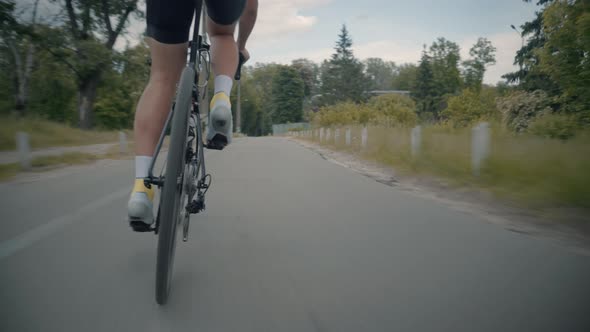 Cyclist Training Leisure Twists Pedals On Triathlon Bicycle. Gear System  And Bike Wheel. alt