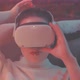Top shot of a young woman laying down and looking into the camera through vr goggles - VideoHive Item for Sale
