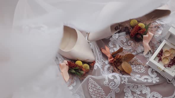 Wedding Rings Flowers Bouquet and Bridal Shoes Accessories for Bride on Window Sill with Curtains alt