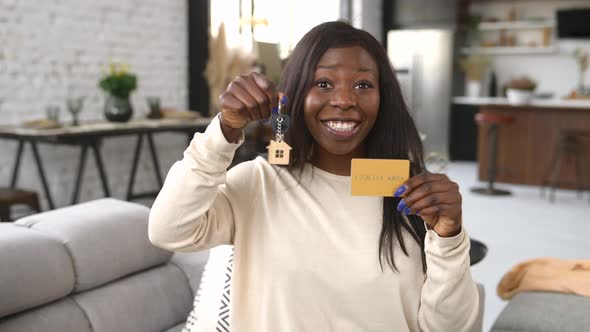 Happy Young Woman Holds Key of New Home