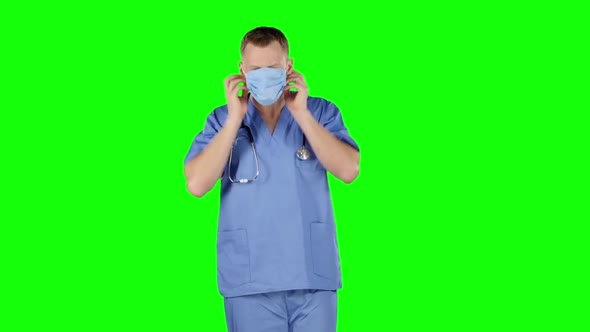 Doctor Puts a Medical Bandage on Face. Green Screen alt