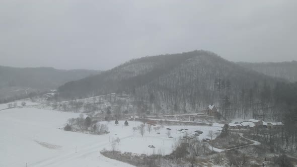 Aerial view of snowy landscape in valley with church nestled in western Wisconsin.