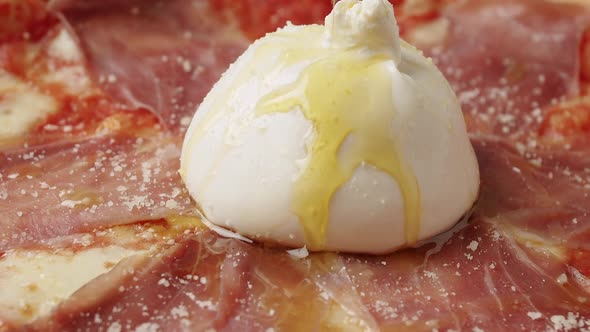 Rotating Prosciutto Pizza with Cheese on White Background alt