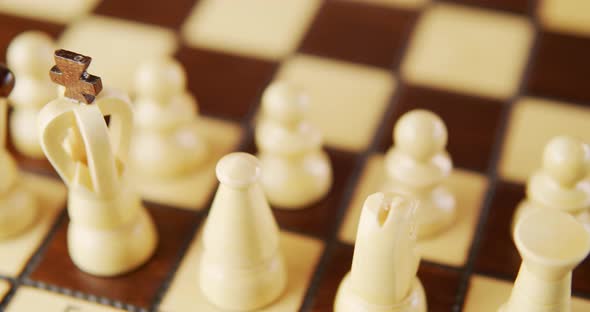 Rotating Old Wooden Chess Pieces on a Chessboard