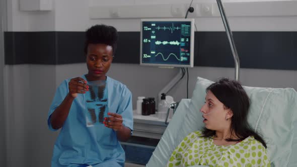 Closeup of Nurse with Black Skin Analyzing Bones Radiography alt