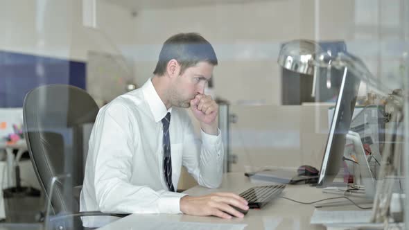 Sick Middle Aged Businessman Working on Office Computer and Doing Coughing alt