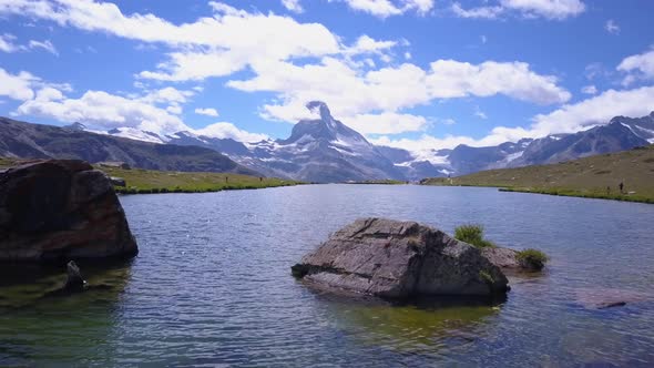Aerial travel drone view of Zermatt at the Stellisee Lake, Mount Matterhorn, Switzerland. alt