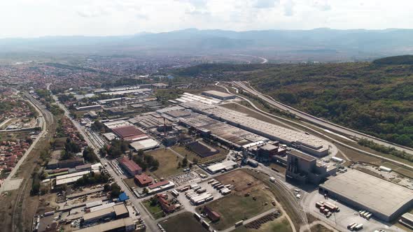 Factory, big. Industrial zone. Camera ascends drone shot moving forward and down