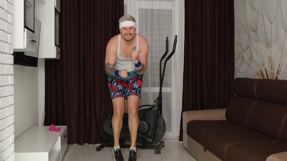 Funny Man Athlete Sportsman Guy with Beard Makes Workout Running Having Fun Fooling Around at Home alt