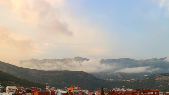 Clouds motion over the buildings in Budva city, Montenegro. 4K time lapse