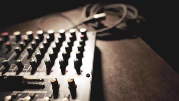 Mixer desk with many buttons and cables