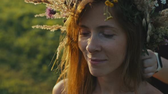 Image of a Girl in a Wreath of Herbs Symbolizing a Bright Warm Blooming Spring