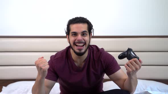Indian gamer playing video games and cheering alt