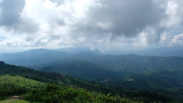 Aerial view of the sky and mountains on cloudy day by drone