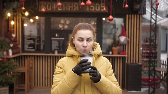 Portrait of Young Woman Drinking Take Away Coffee alt