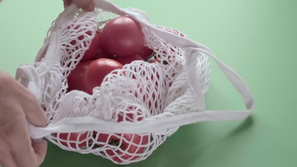 Man is Shopping Organic Vegetables in Zero Waste Eco Shop with Mesh Bag alt