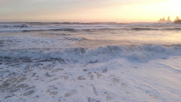 Drone Over Sunlit Sea With Sea Stacks At Sunset alt