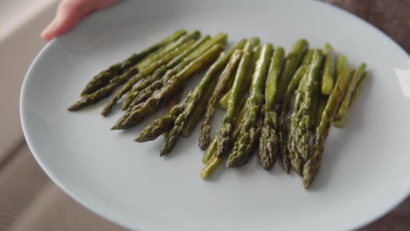 Appetizing Organic Fried in Oil Green Asparagus Ready to Eat on a Plate