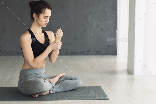 Woman checking pulse after yoga training, free space