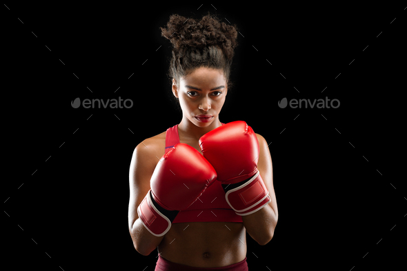 Portrait of young woman in boxing gloves