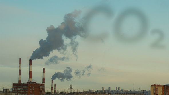 Factory Chimney Smokes on the Industrial Background and CO2 Sign in Smoke Cloud