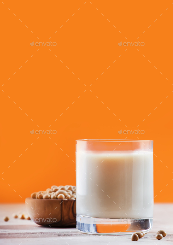 Soy milk and soy bean on orange background