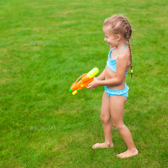 Adorable Little Girl Playing with Water Gun on Hot Summer Day. Cute Child  Having Fun with Water Outdoors Stock Photo - Image of leisure, beautiful:  97180460