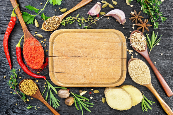 Frame of spices and herbs with plate on black board top - Stock Photo - Images