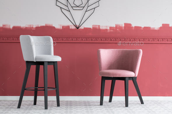 Pastel pink and grey velvet bar stools in empty interior with burgundy and white ombre wall