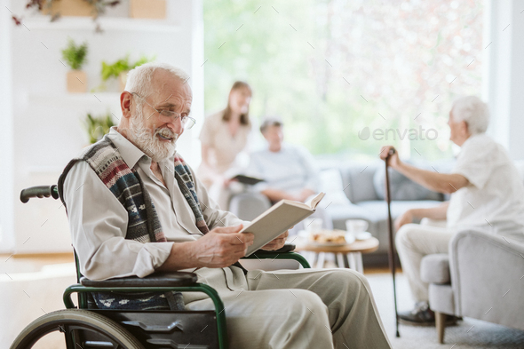 Senior people during afternoon in the nursing home living room Stock Photo  by bialasiewicz