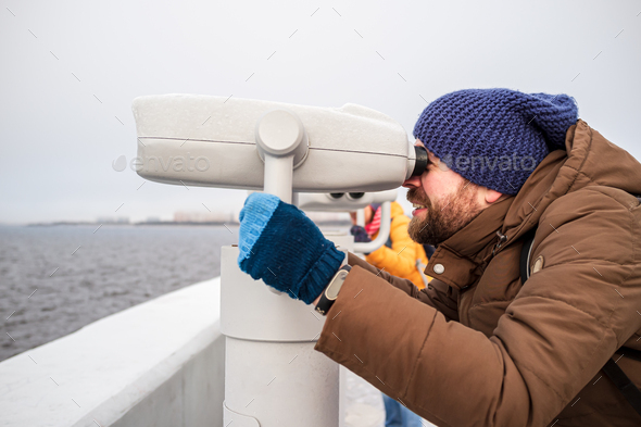 Man looks with interest in the tower viewer - Stock Photo - Images