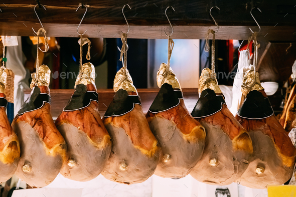Hanging Italian Dry-cured Ham Prosciutto In Shop. Italian Cuisine