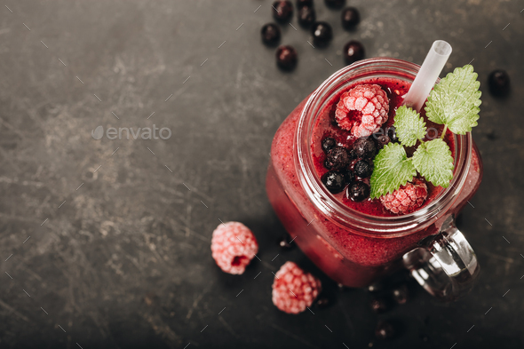 Berry smoothie on rustic wooden background - Stock Photo - Images